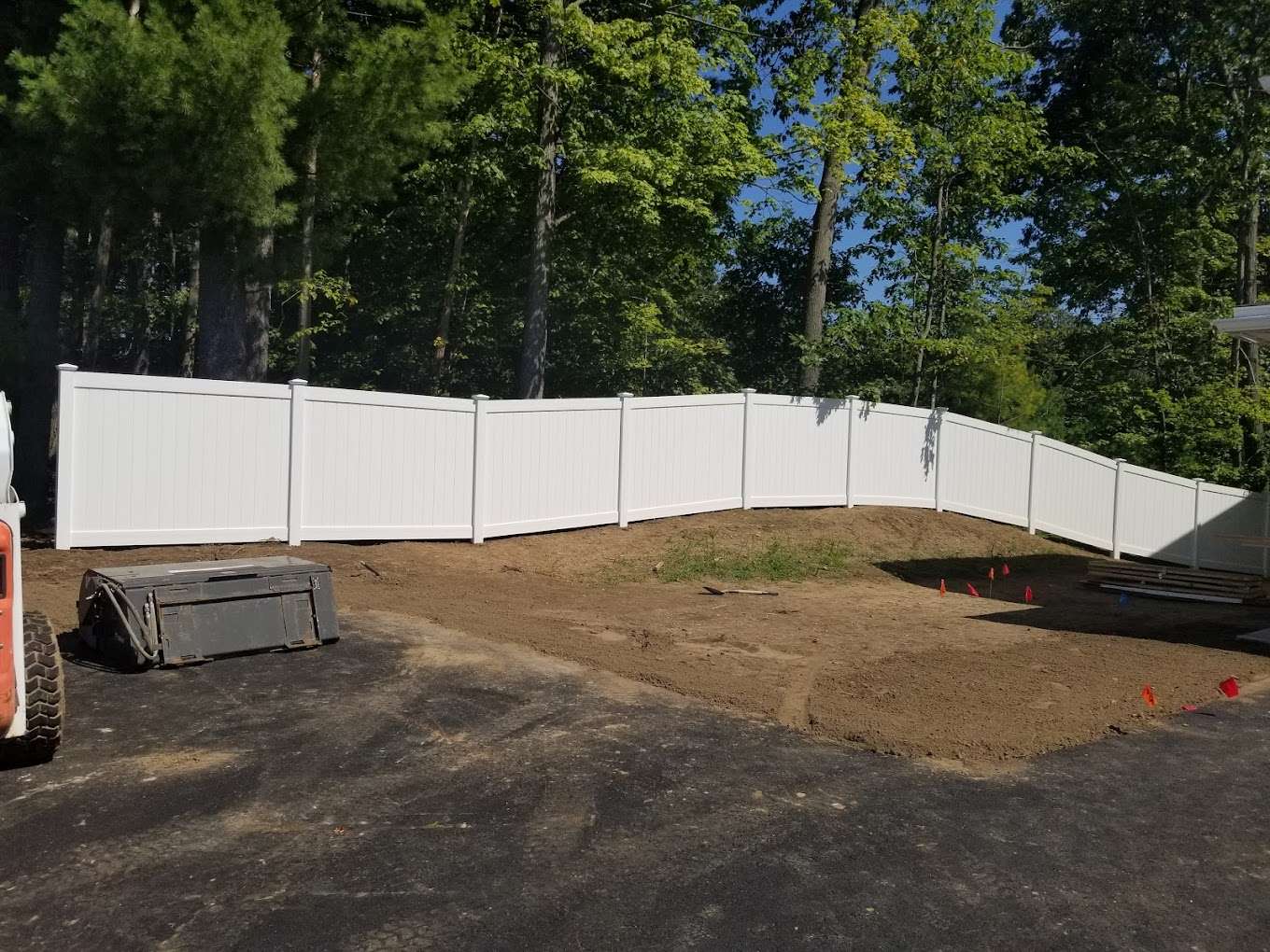 Olympic Fence Company installing a white vinyl privacy fence in the North Shore, Massachusetts, showcasing durable fencing options.