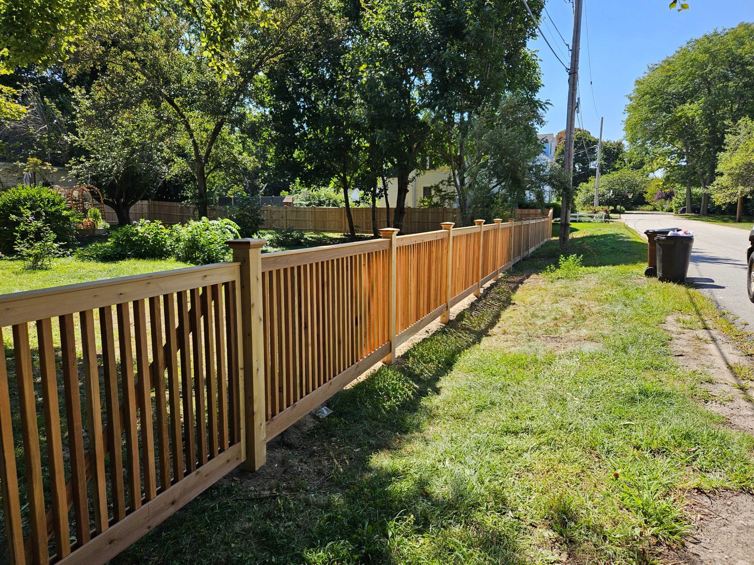 Cedar fence installation showcasing a modern shadowbox design, emphasizing natural beauty and durability in a residential setting.