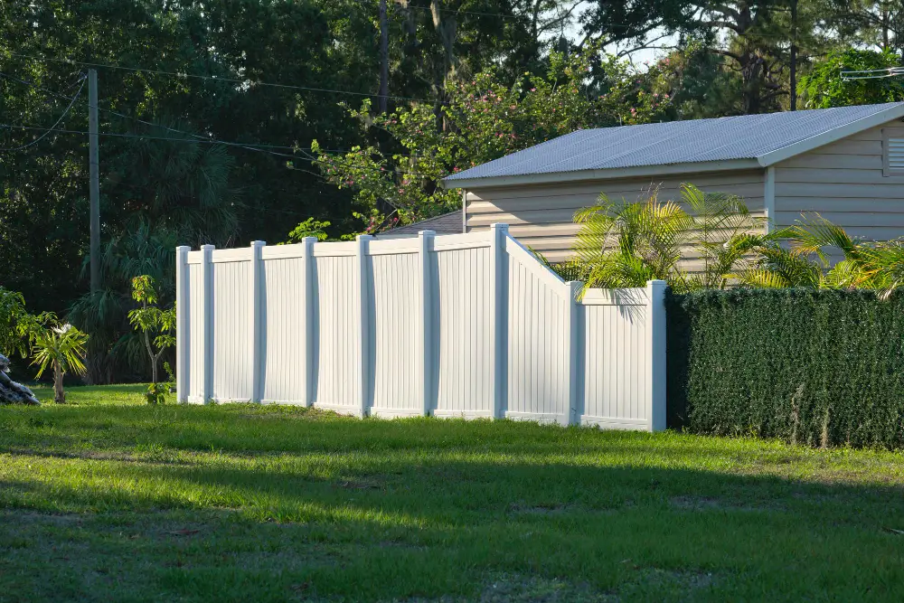 Olympic Fence Company vinyl fence installation in Newburyport, MA, featuring a white picket fence and lifetime workmanship warranty.