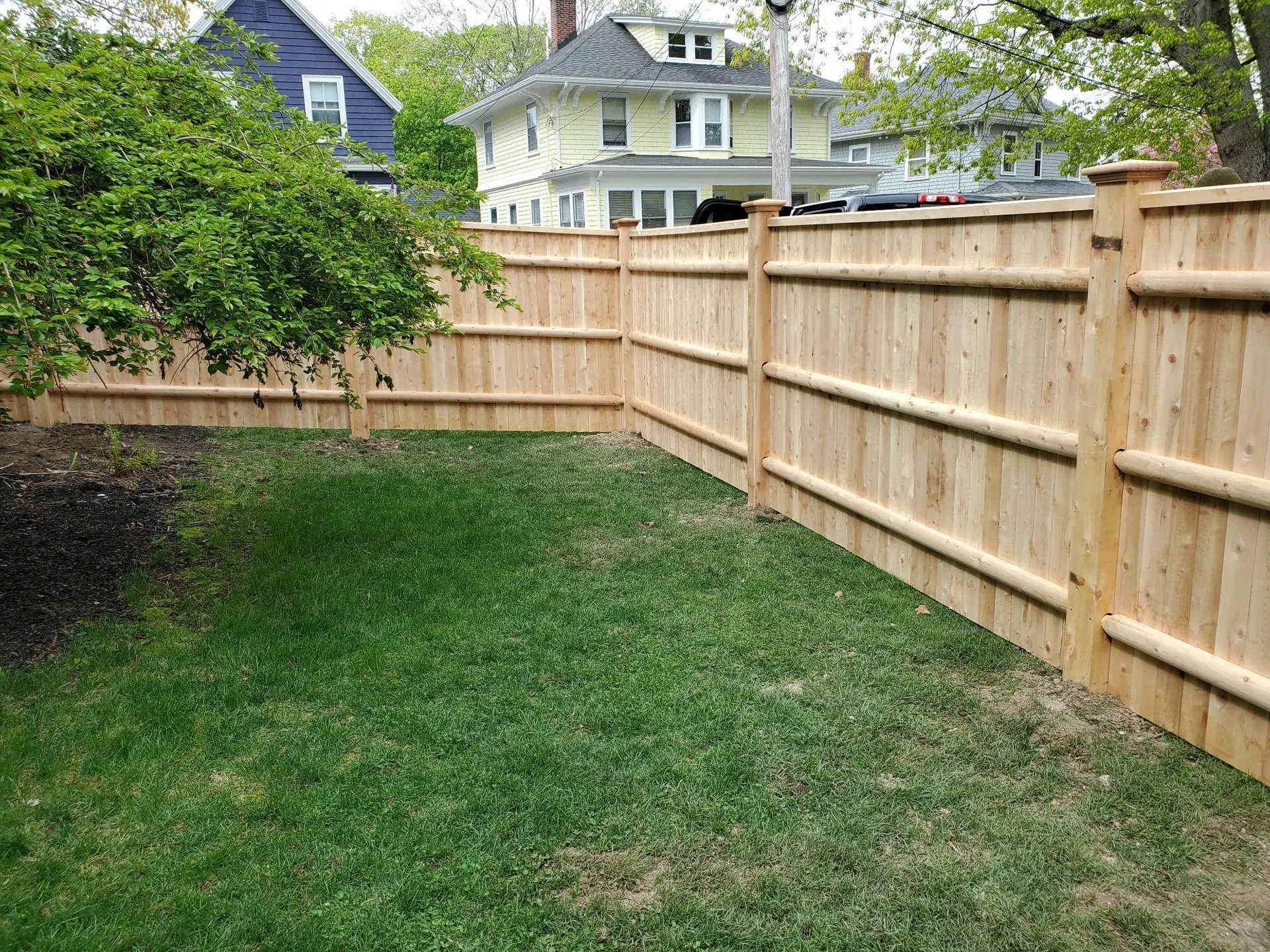 Cedar privacy fence installation by Olympic Fence Company on the North Shore, featuring wood-on-steel posts and a lifetime workmanship warranty.