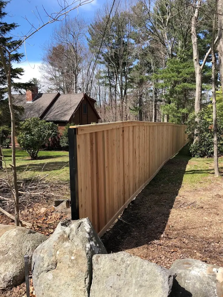 Wood-on-steel fence installation by Olympic Fence Company in the North Shore, featuring a natural wood look and galvanized steel posts for a lifetime workmanship warranty.
