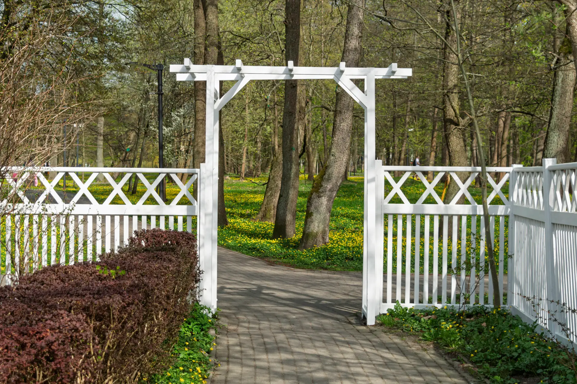 White garden gate and path leading to a scenic park on the North Shore, Olympic Fence Company.