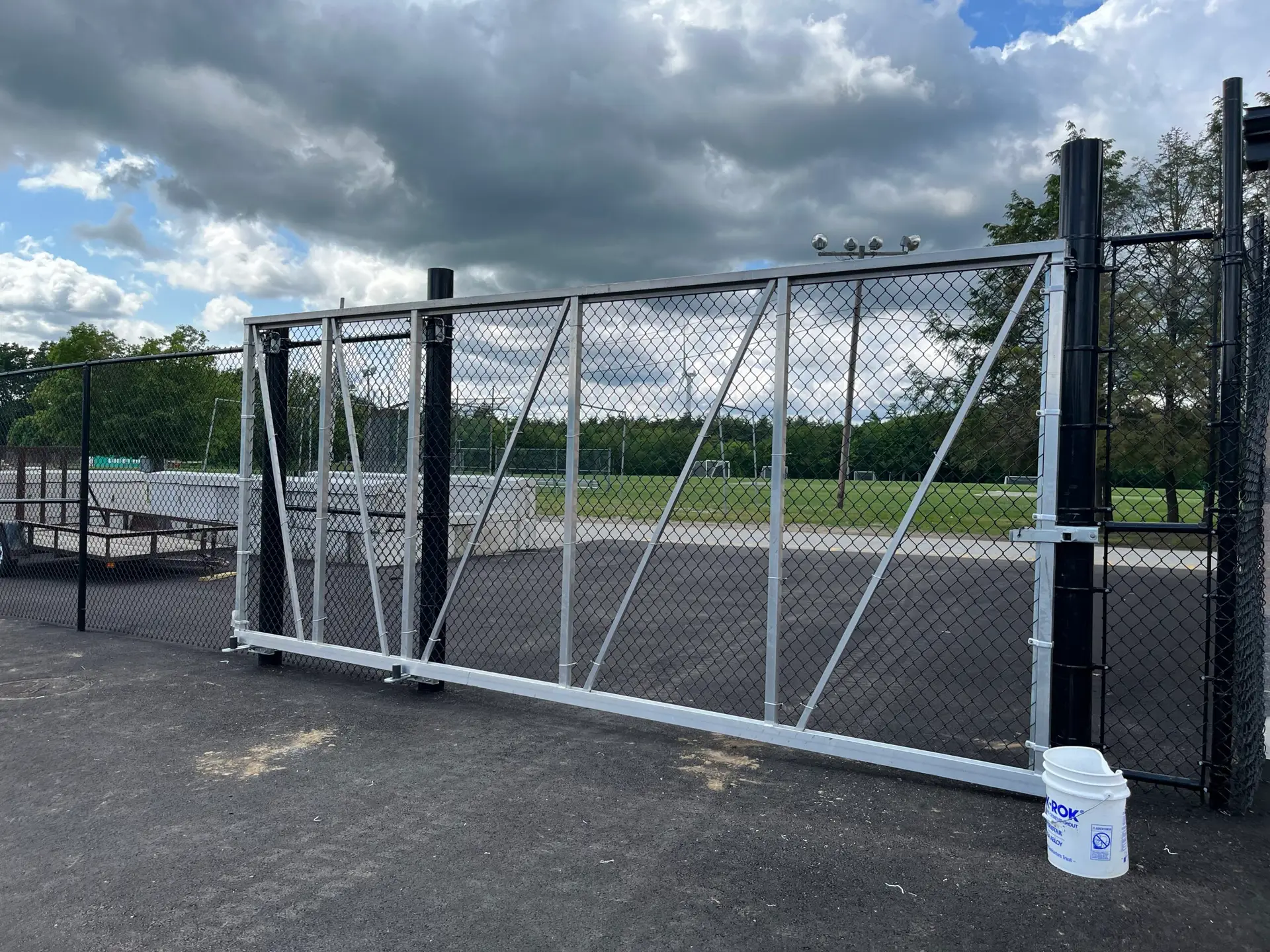 Olympic Fence Co. installed double drive gate for commercial property in the North Shore, featuring galvanized hardware and chain link fencing.