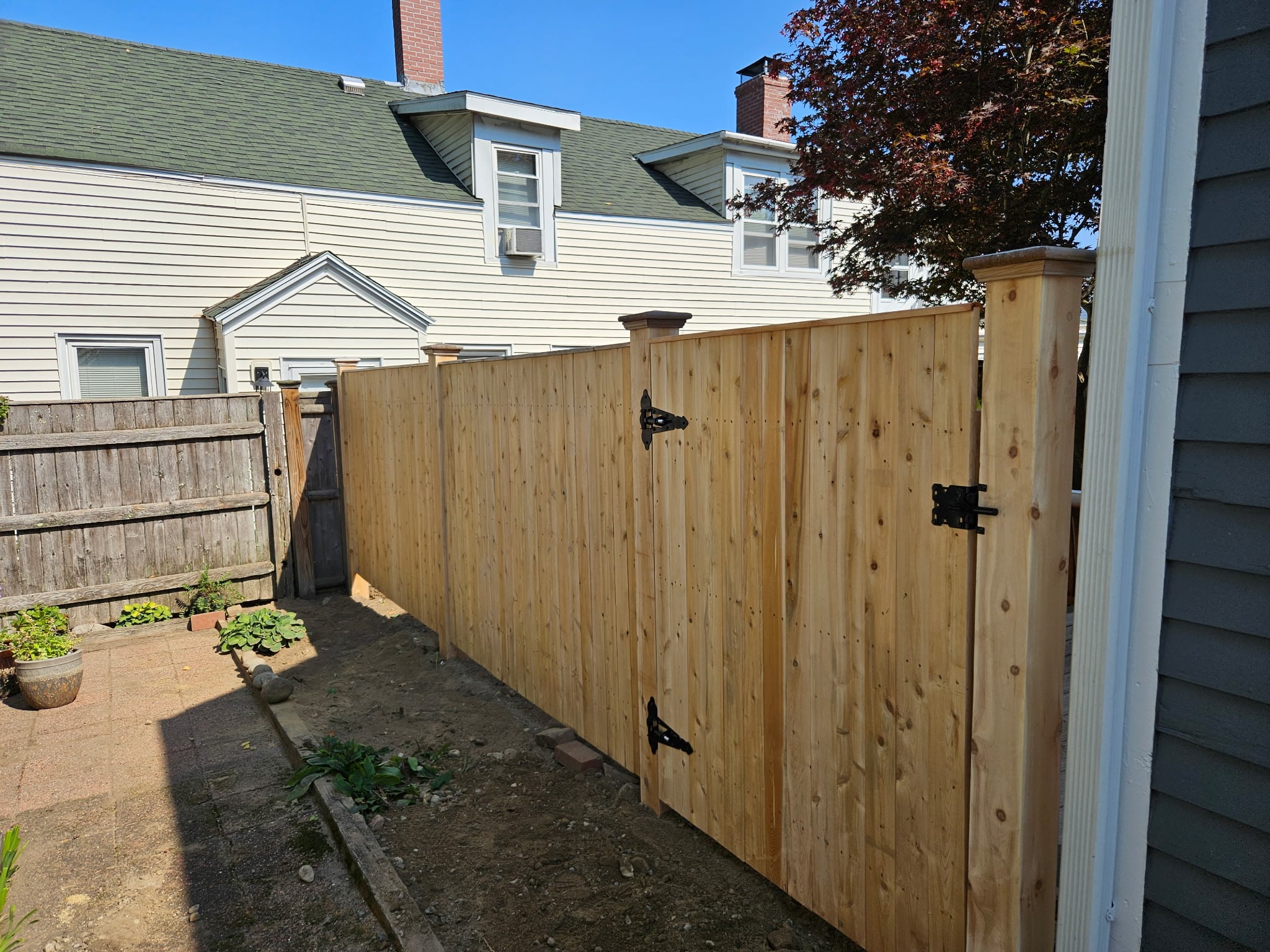 Wood-on-steel fence installation by Olympic Fence Company in the North Shore, featuring a lifetime workmanship warranty.