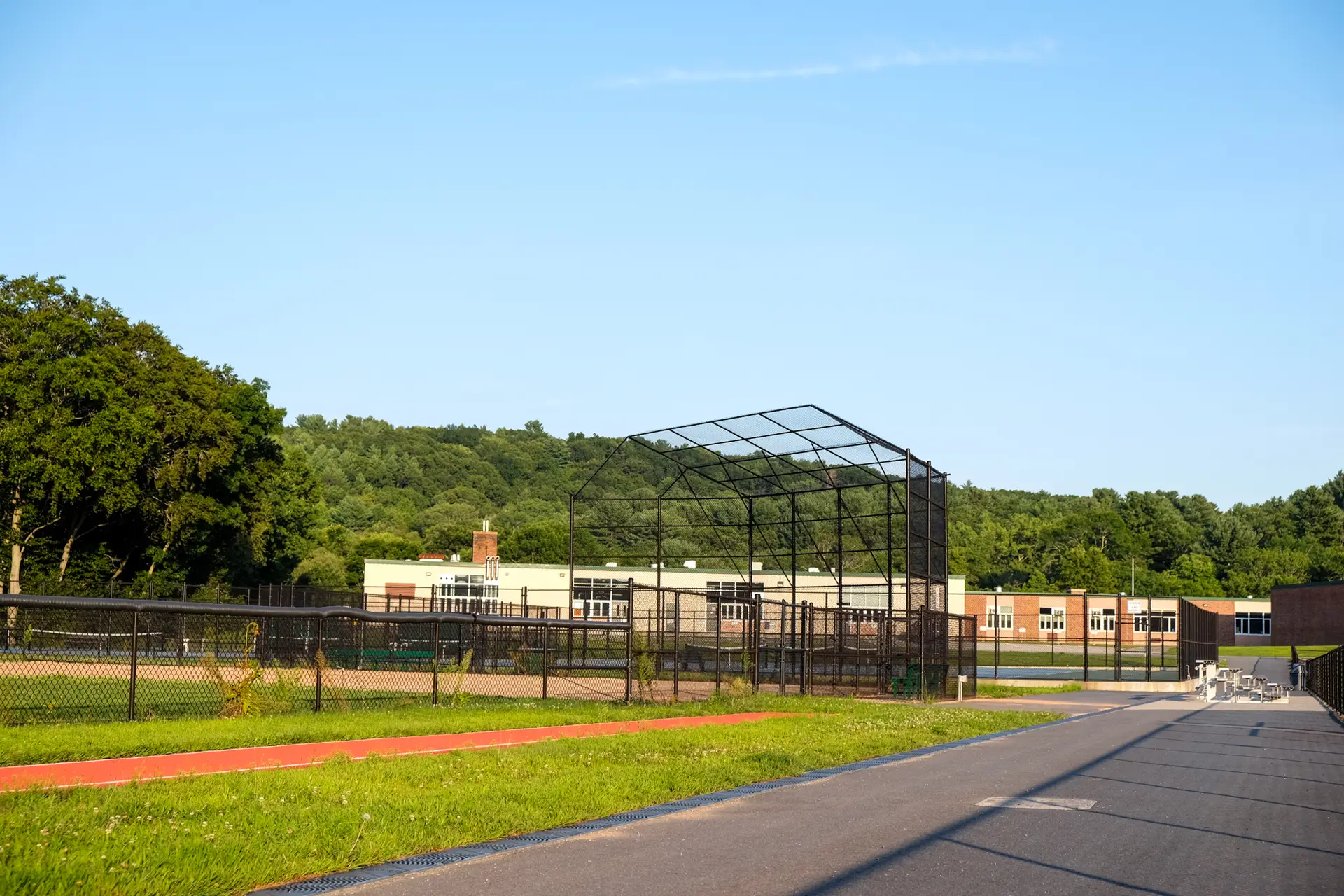 Municipal baseball field perimeter with chain link fencing installed by Olympic Fence Company in West Newbury.