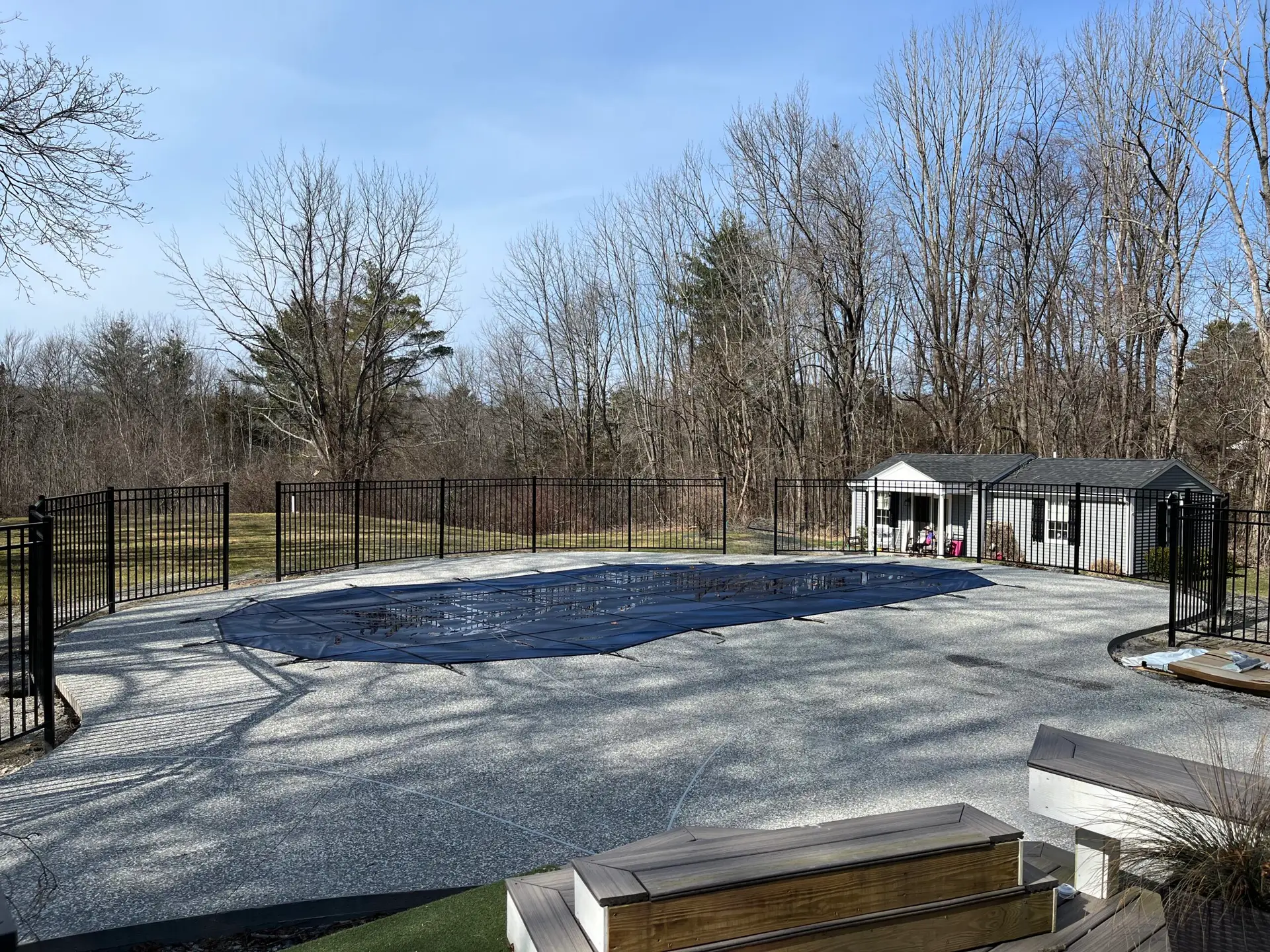 Aluminum pool fencing installation by Olympic Fence Company in West Newbury, Massachusetts, surrounding an in-ground pool.