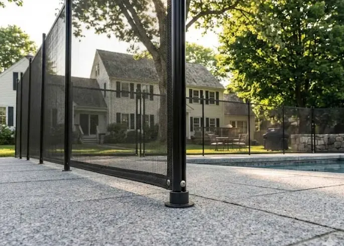 Rigid wire panel pool fencing surrounding a swimming pool, providing visibility and safety, with a residential backyard setting in Salisbury, MA.