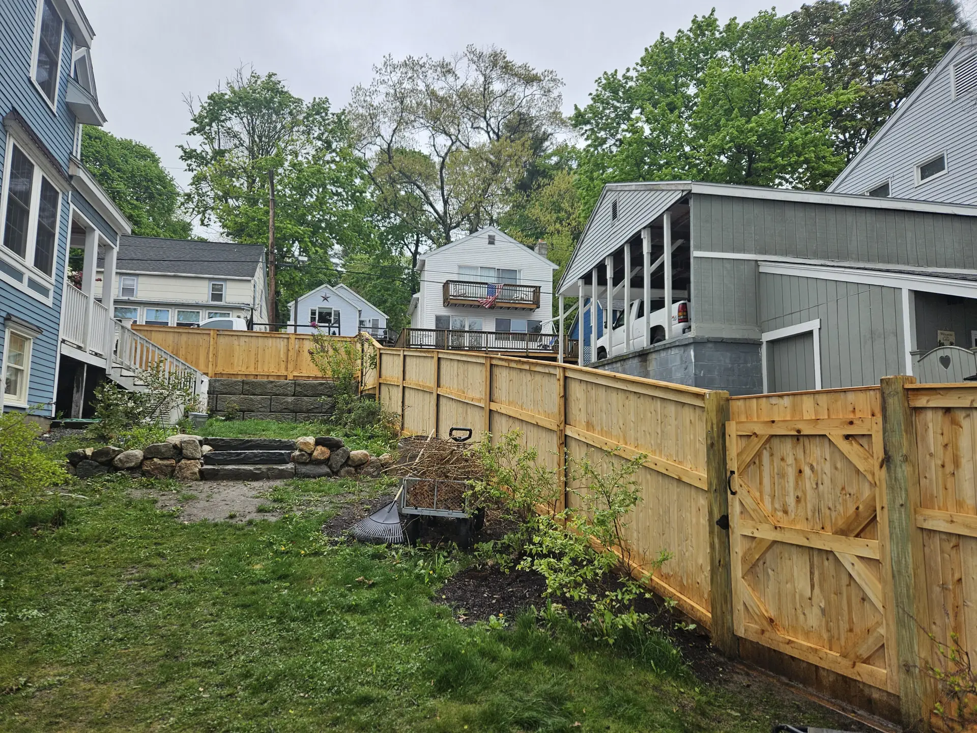 Backyard with wooden fence and stone pathway