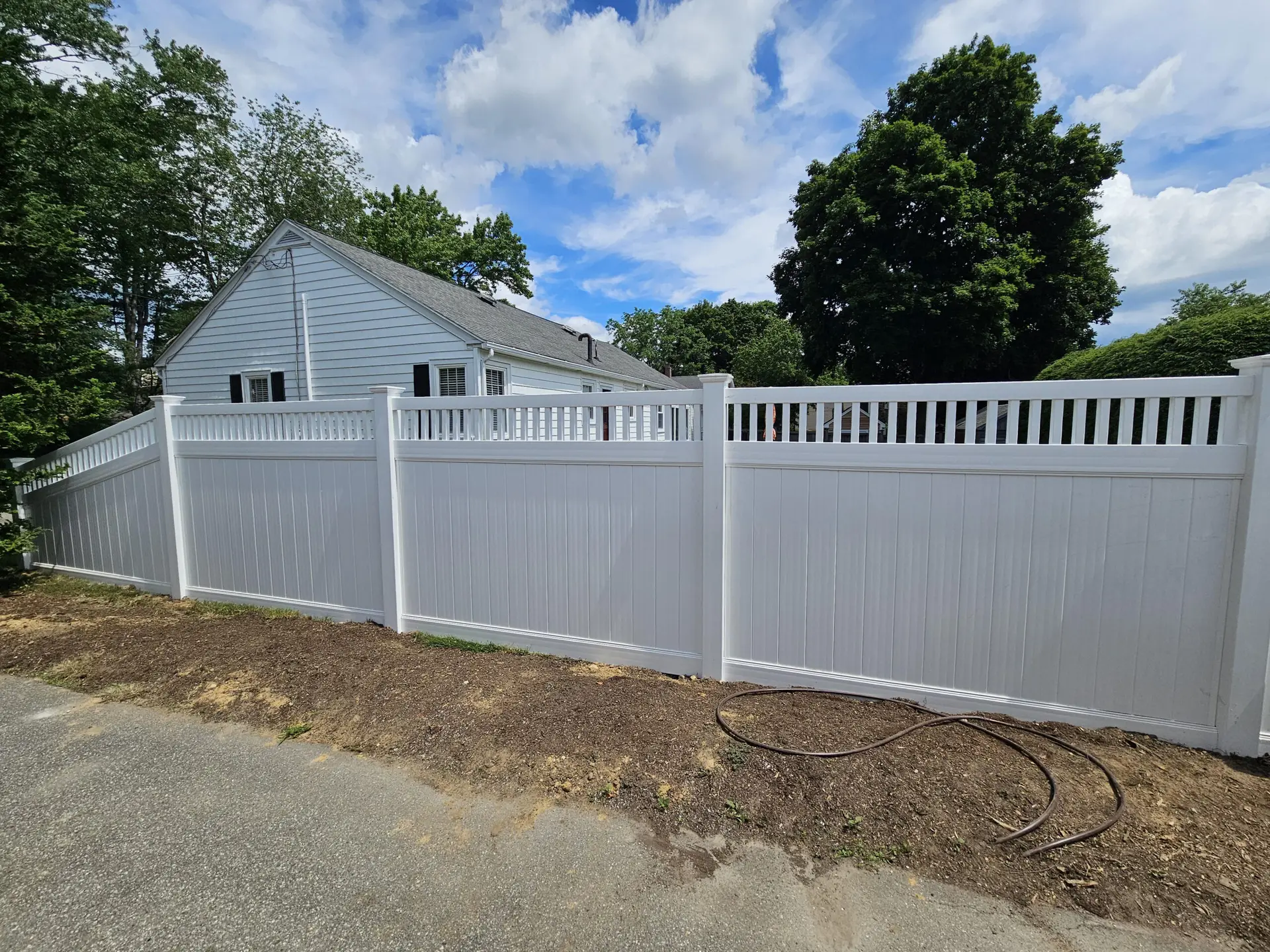 White vinyl fence next to a house