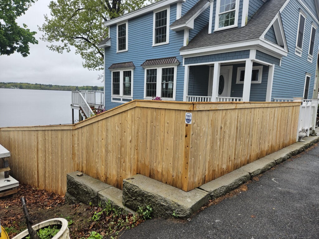 Wooden fence surrounding a residential property by the water